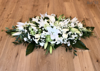 White and green floral coffin spray.